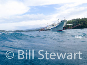 Our bangka boat approaches us for pickup after a dive in Manila Channel, Puerto Galera, Philippines.